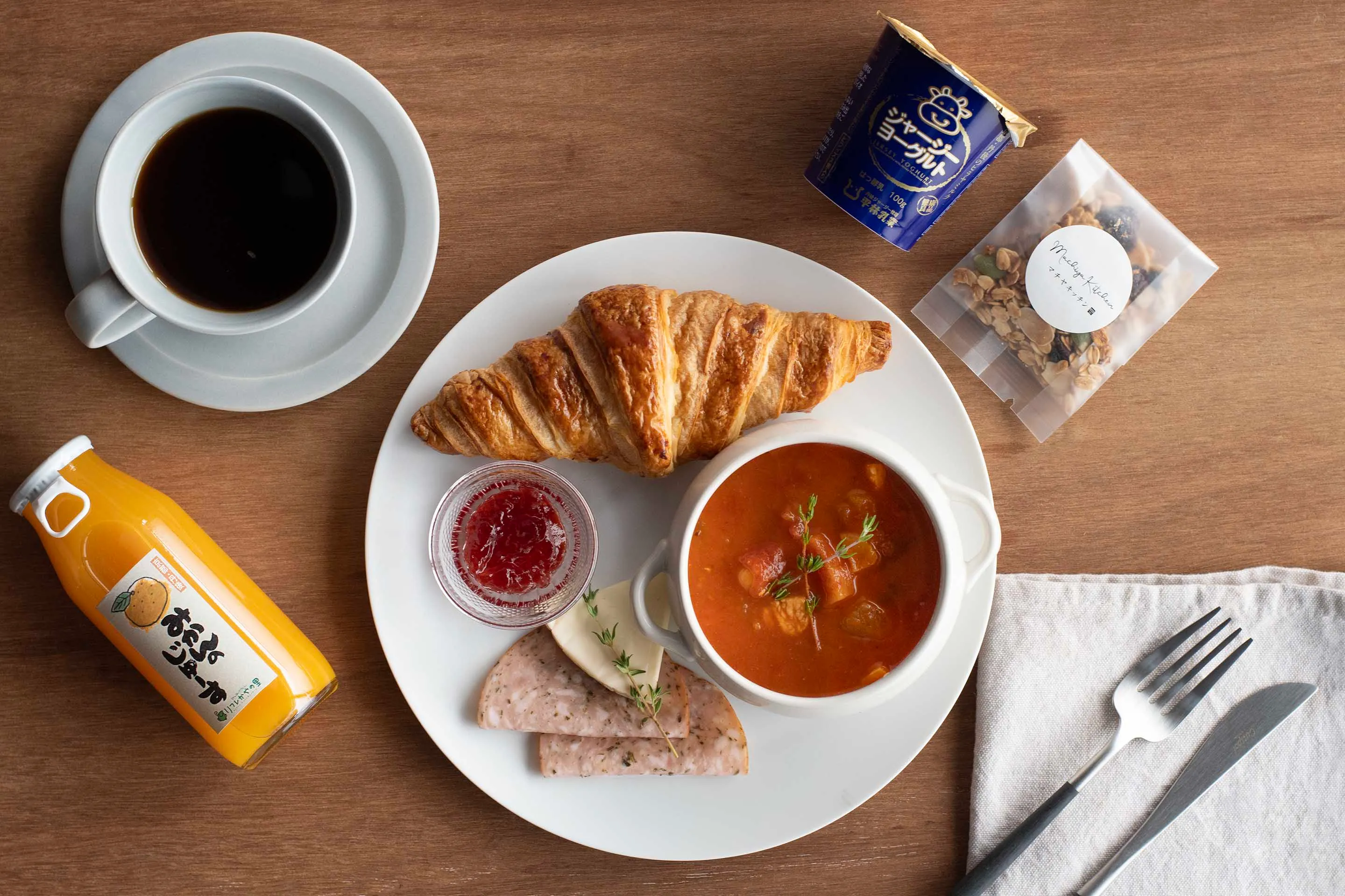 The LBJ株式会社 Breakfast BENTO Box, plated with croissant, soup, yogurt and juice